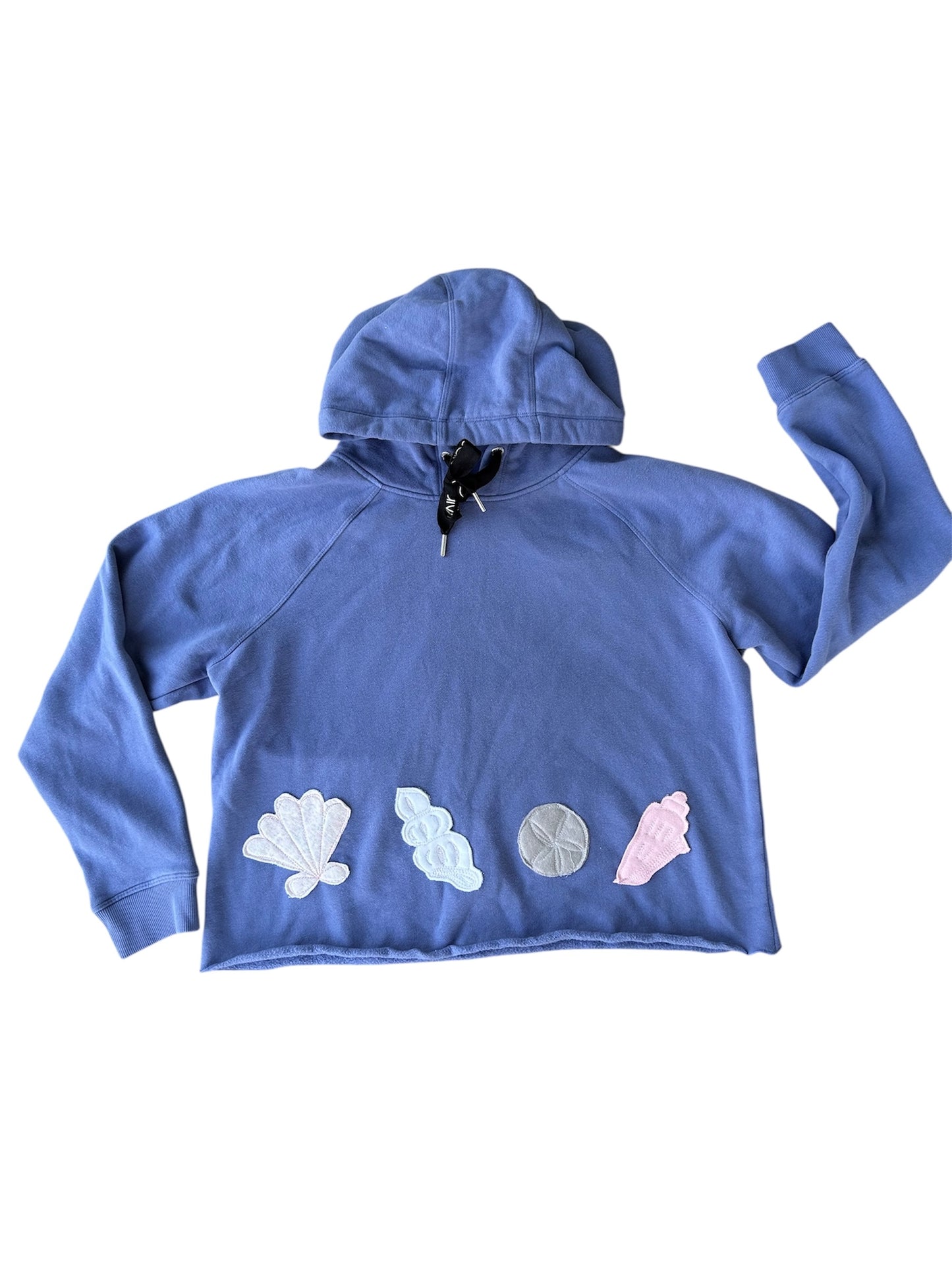 Blue hoodie with colorful seashell patches on a white background