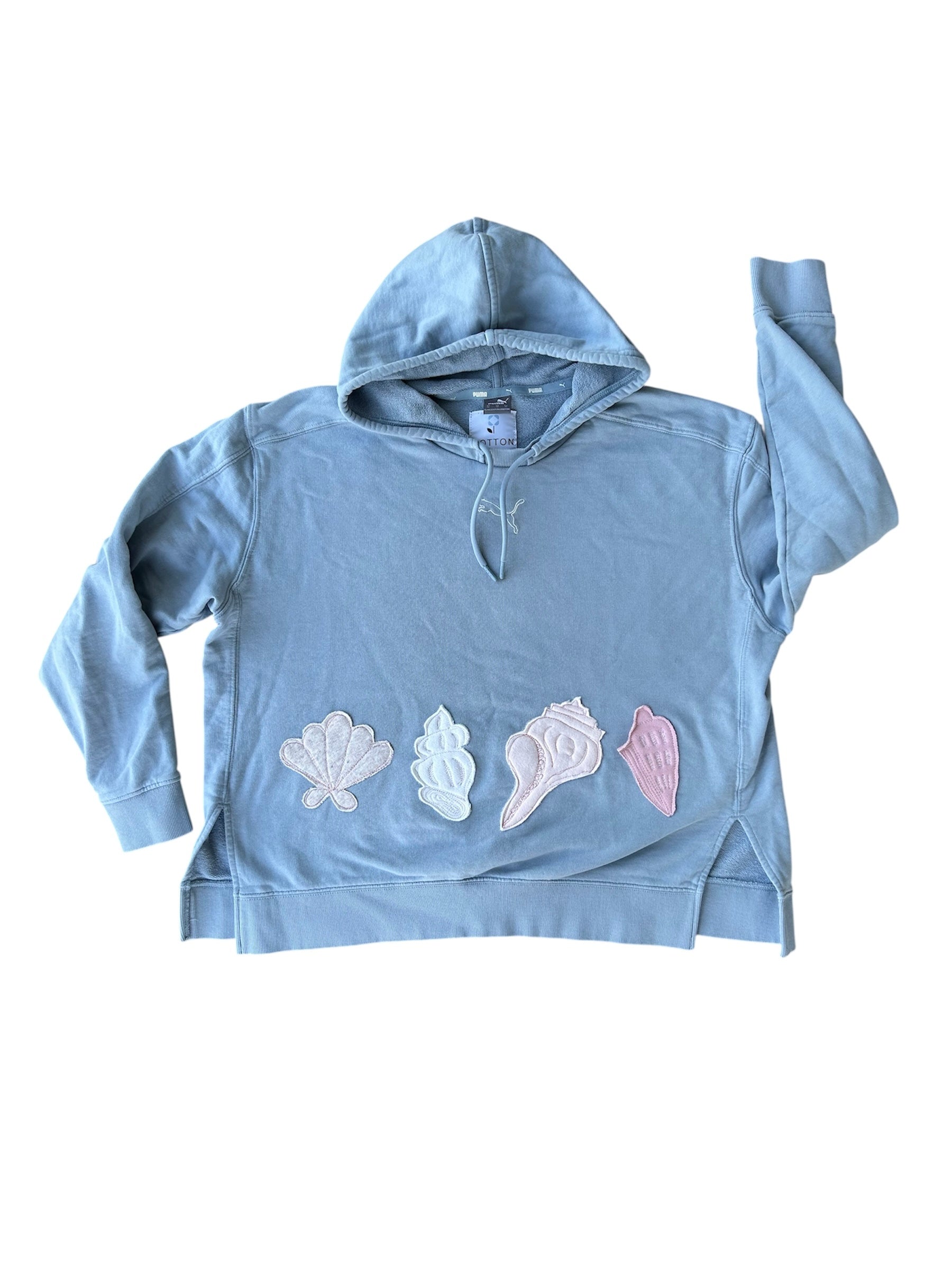 Light blue hoodie with shell designs on a white background