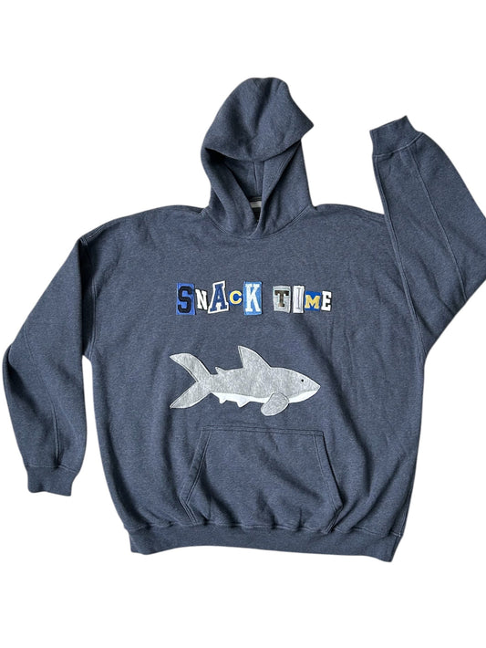 A gray hoodie with 'SNACK TIME' text and a shark graphic on the front.