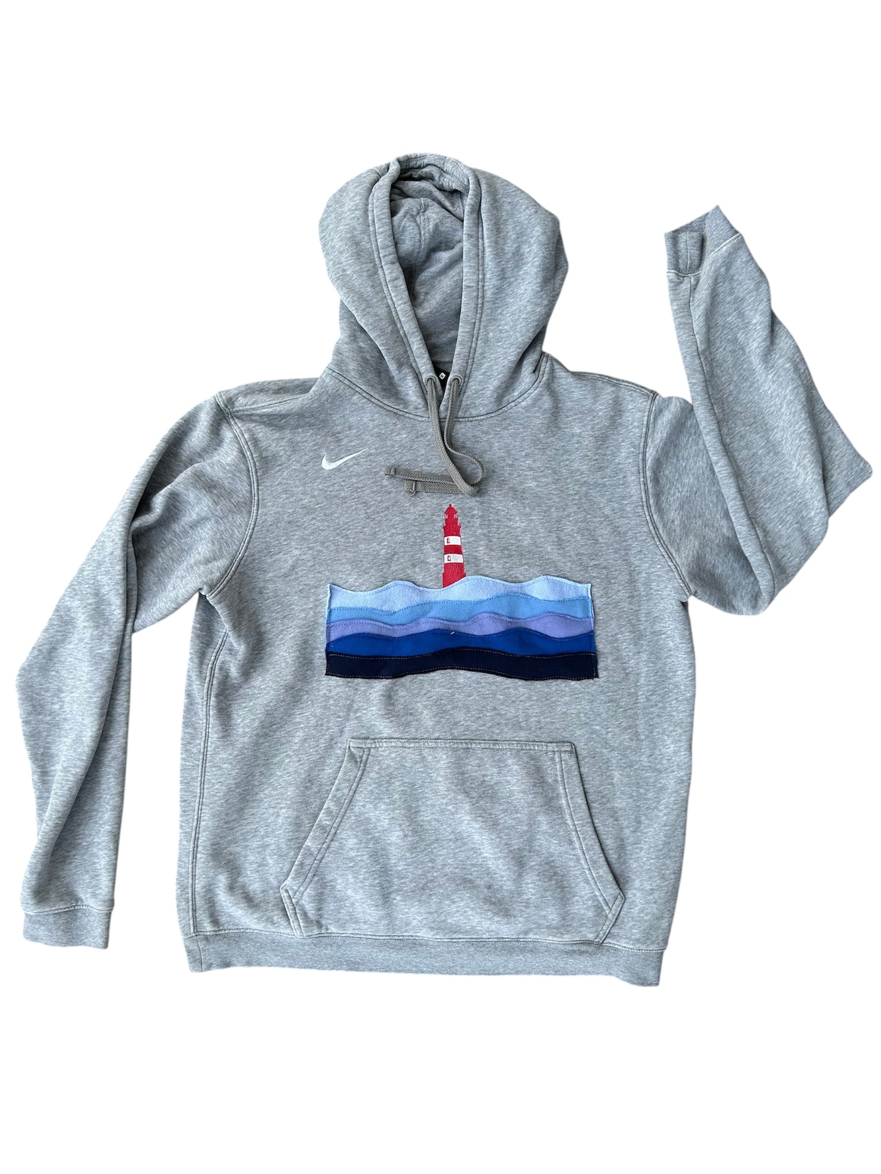 Gray hoodie with a lighthouse design on a white background