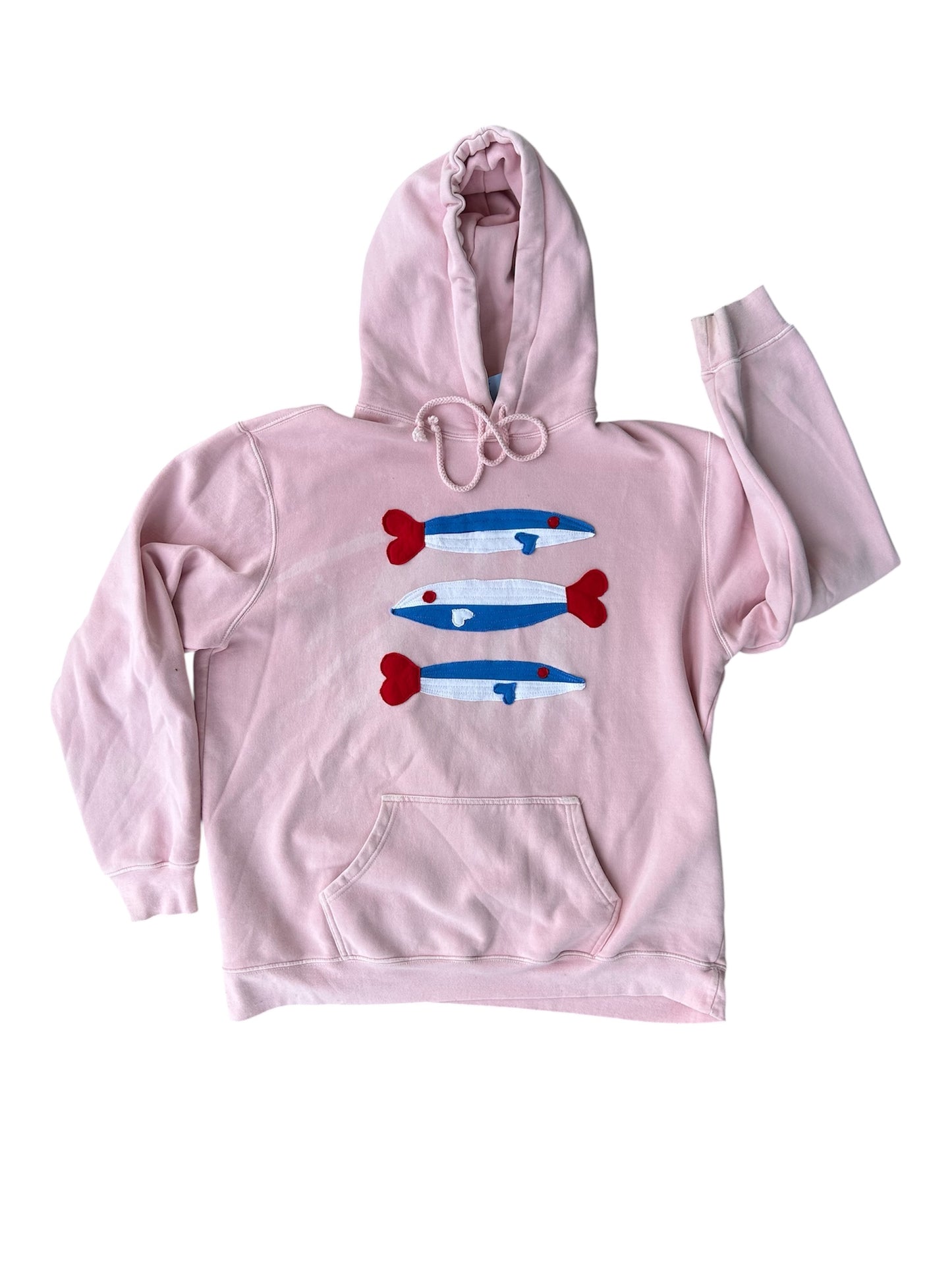Pink hoodie with graphic design on a white background