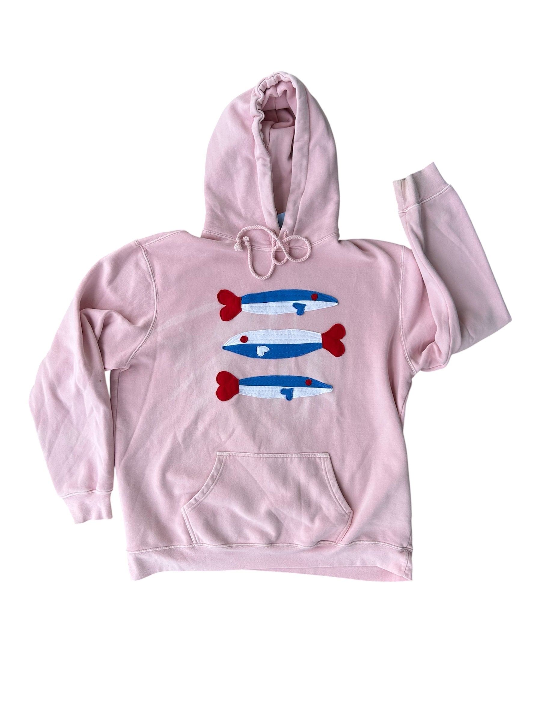 Pink hoodie with graphic design on a white background